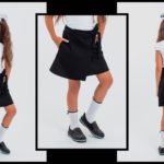 Приобрести недорого юбку с запахом детскую школьную из трикотажа итальянского с поясом для девочек черного цвета оптом Украина